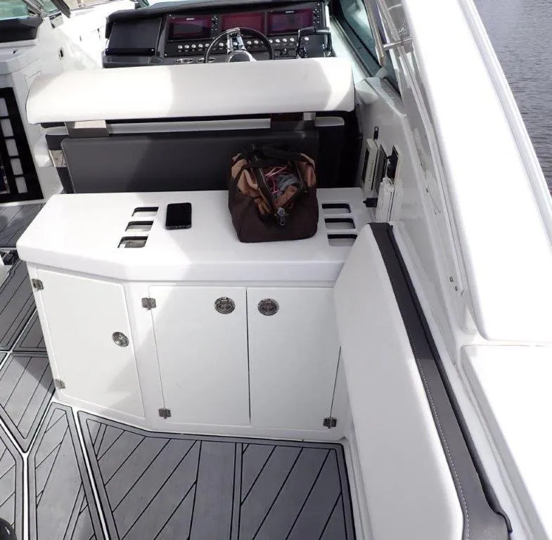 Slide: The Image of 2023 Monterey 385 Super Sport boat interior with seating and storage compartments. - 18