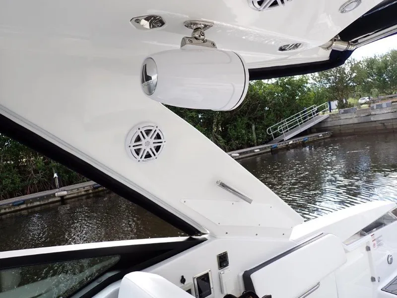 Slide: The Image of 2023 Monterey 385 Super Sport boat interior with speakers and sleek design by the water. - 23