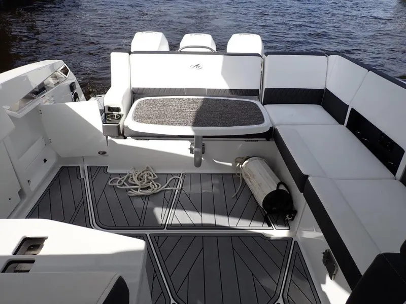 Slide: The Image of 2023 Monterey 385 Super Sport boat interior with white seating and gray flooring. - 25