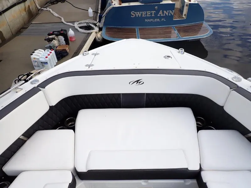 Slide: The Image of 2023 Monterey 385 Super Sport boat interior with white seating at dock. - 3