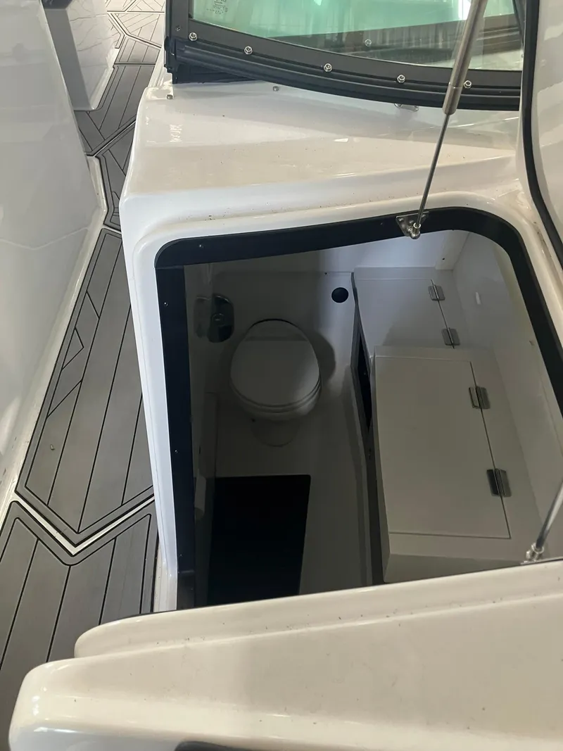Slide: The Image of 2023 Monterey 385 Super Sport boat interior with compact bathroom and modern design. - 36