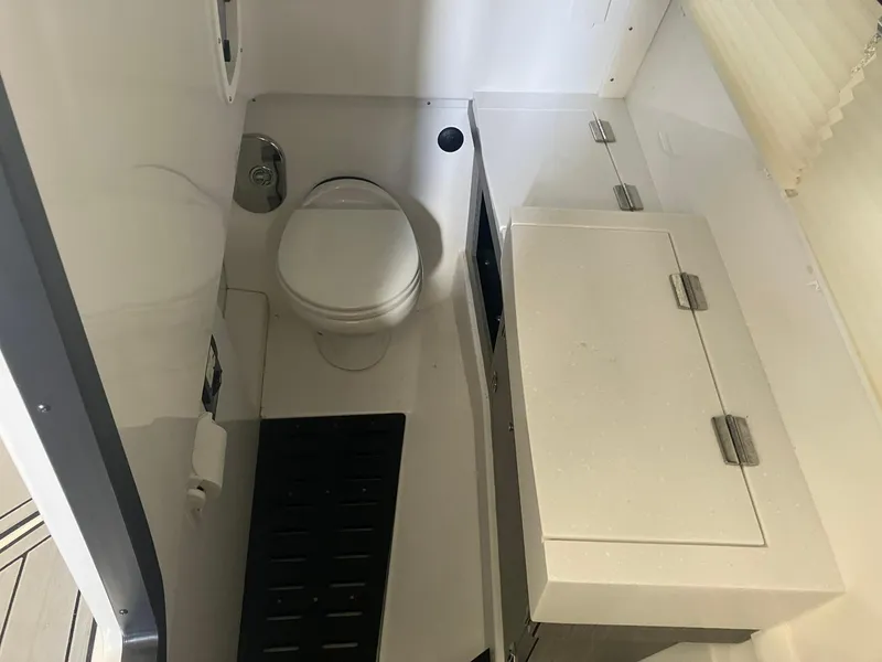 Slide: The Image of 2023 Monterey 385 Super Sport boat bathroom with toilet and storage cabinet. - 37