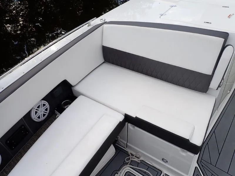 Slide: The Image of 2023 Monterey 385 Super Sport boat interior with white cushioned seating. - 4