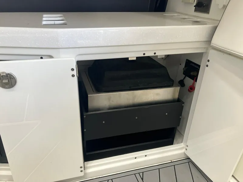 Slide: The Image of 2023 Monterey 385 Super Sport boat interior storage compartment with open cabinet door. - 40