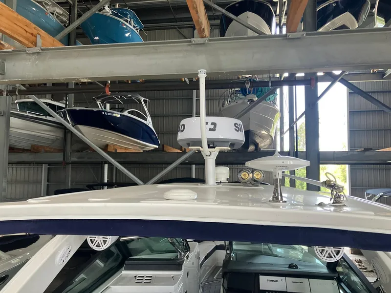 Slide: The Image of 2023 Monterey 385 Super Sport in storage, surrounded by other boats in a warehouse. - 49