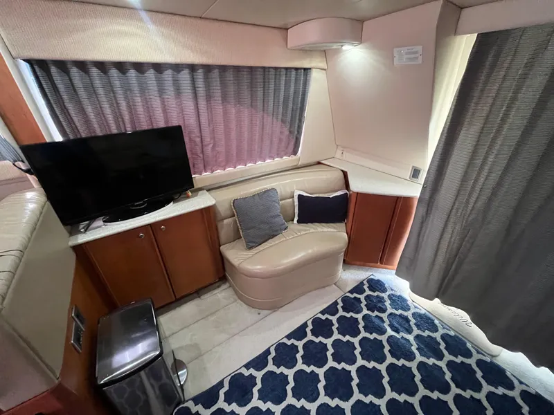 Slide: The Image of Interior of 2003 Meridian 381 Sedan with TV, seating, and patterned rug. - 13