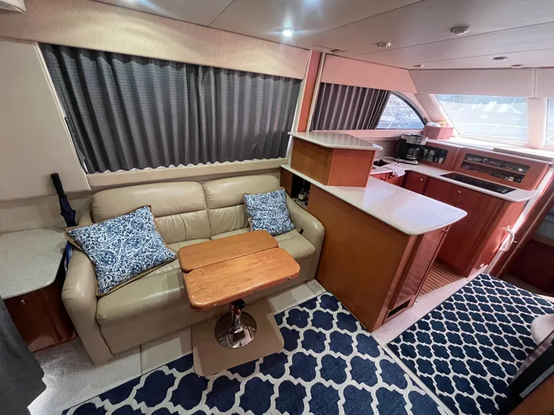 Slide: The Image of Interior of 2003 Meridian 381 Sedan yacht with cozy seating and modern kitchen area. - 14