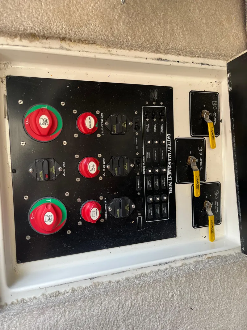Slide: The Image of Electrical panel of a 2003 Meridian 381 Sedan boat with switches and controls. - 16