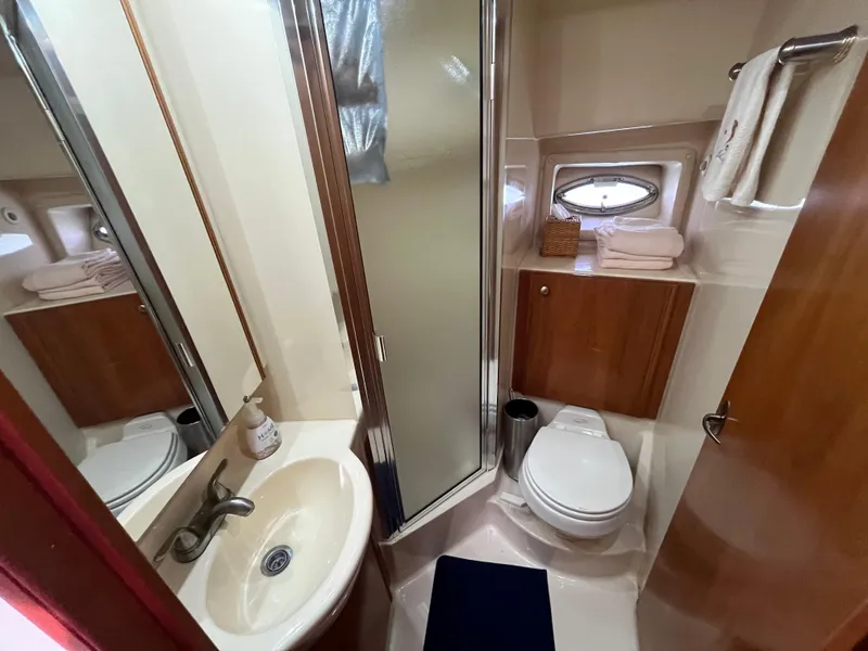 Slide: The Image of Compact bathroom in 2003 Meridian 381 Sedan yacht with shower, sink, and toilet. - 17