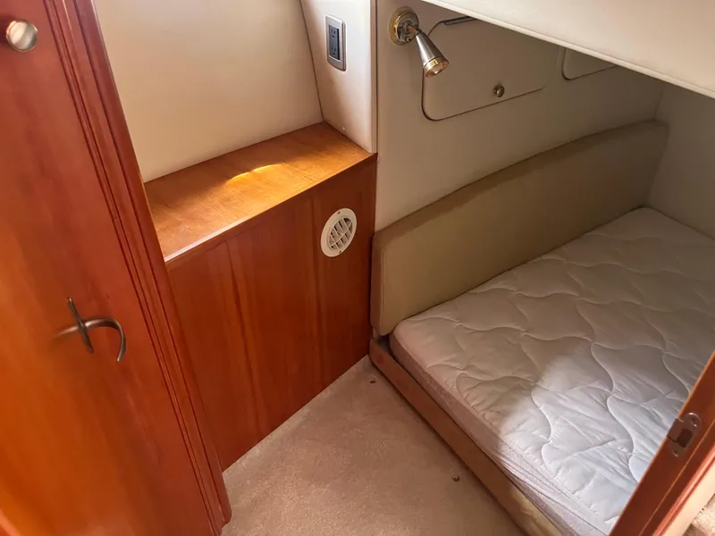Slide: The Image of 2003 Meridian 381 Sedan cabin interior with bed, wooden cabinetry, and reading light. - 18