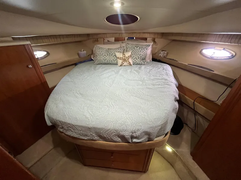 Slide: The Image of Cozy bedroom in 2003 Meridian 381 Sedan yacht with elegant bedding and ambient lighting. - 19