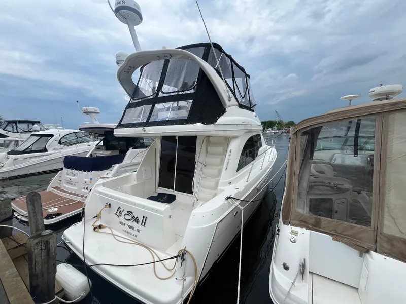 Slide: The Image of 2003 Meridian 381 Sedan yacht docked at marina under cloudy sky. - 20