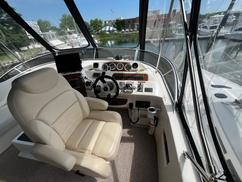 Slide: The Image of Helm of 2003 Meridian 381 Sedan with leather seat and control panel, docked at marina. - 6