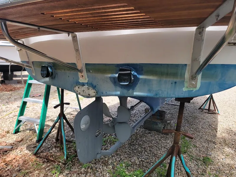 Slide: The Image of 1971 Dyer 29 Classic Downeast Bass Boat on stands, showing propeller and rudder. - 13