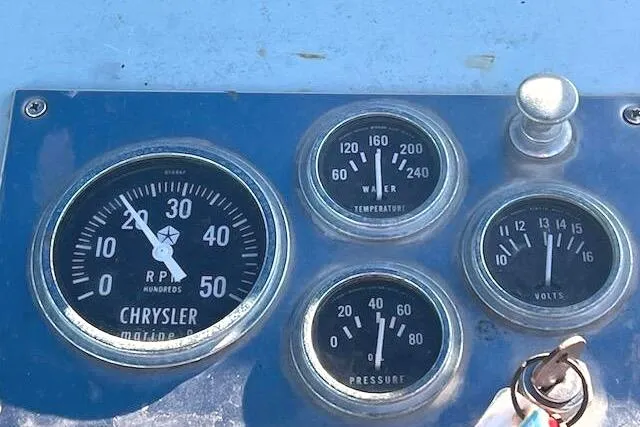 Slide: The Image of 1971 Dyer 29 boat dashboard with Chrysler marine gauges for RPM, water temperature, pressure, and volts. - 2