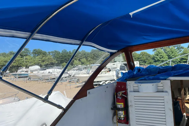 Slide: The Image of 1971 Dyer 29 classic downeast bass boat interior with blue canopy and fire extinguisher. - 20