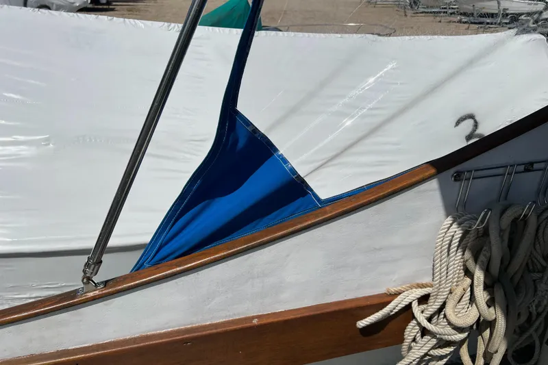 Slide: The Image of 1971 Dyer 29 classic downeast bass boat with ropes and blue cover detail. - 21