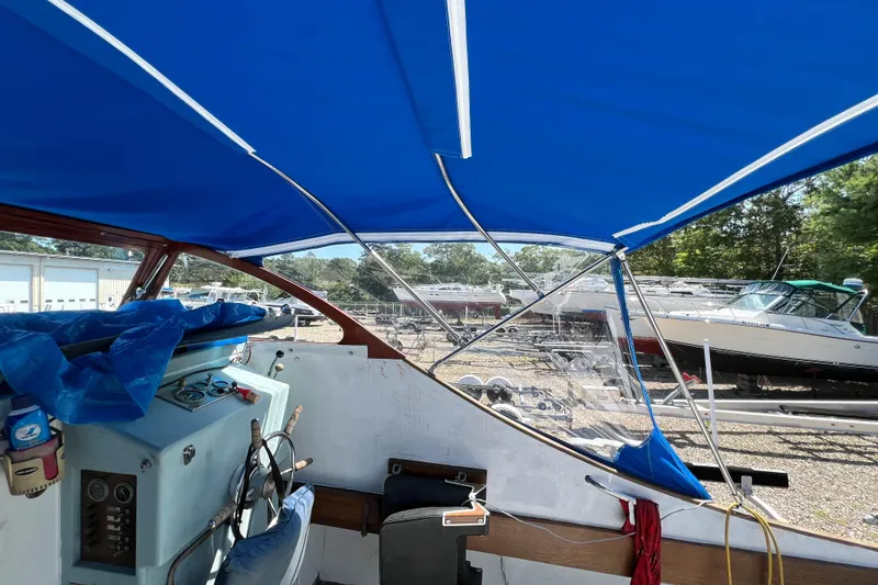 Slide: The Image of 1971 Dyer 29 classic downeast bass boat interior with blue canopy and control panel. - 22