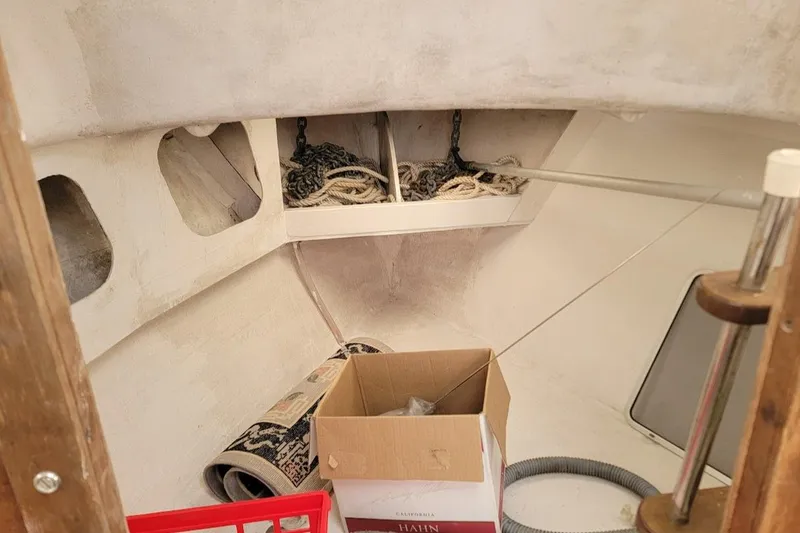 Slide: The Image of 1971 Dyer 29 classic downeast bass boat interior with storage and ropes. - 25