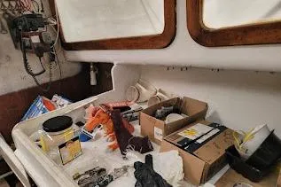 Slide: The Image of 1971 Dyer 29 classic downeast bass boat interior with tools and supplies on counter. - 27