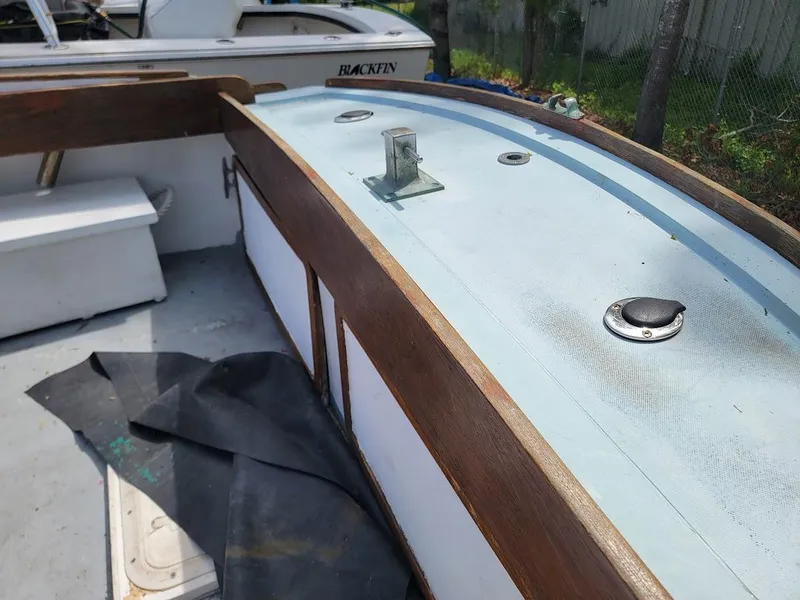 Slide: The Image of 1971 Dyer 29 Classic Downeast Bass Boat deck with wooden trim and metal fixtures. - 29