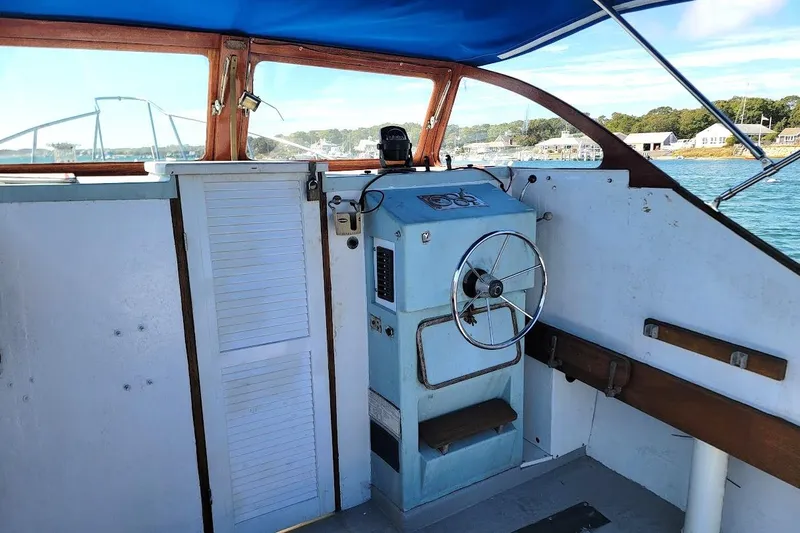Slide: The Image of 1971 Dyer 29 classic downeast bass boat interior with steering wheel and blue console. - 3