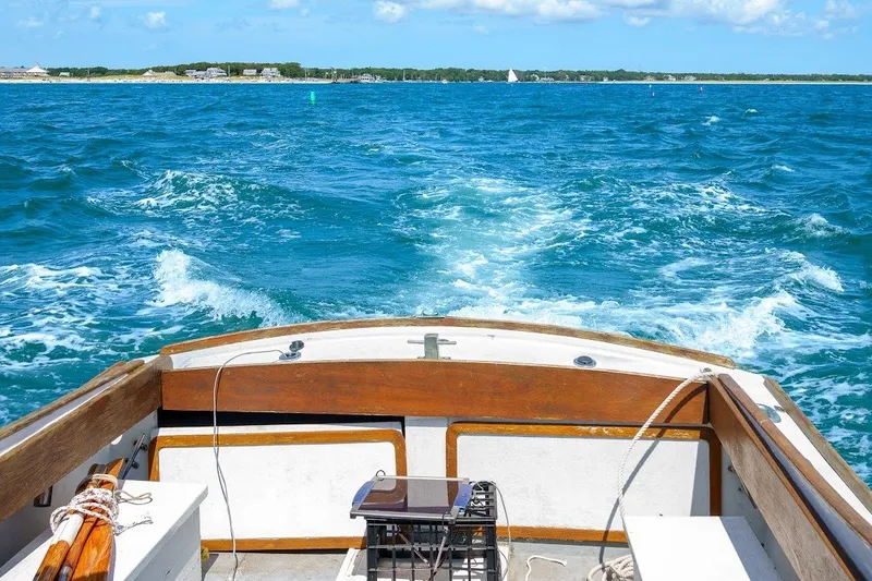 Slide: The Image of 1971 Dyer 29 classic downeast bass boat cruising on blue ocean waters. - 3
