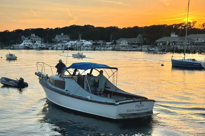 Slide: The Image of 1971 Dyer 29 classic downeast bass boat at sunset in a harbor setting. - 6
