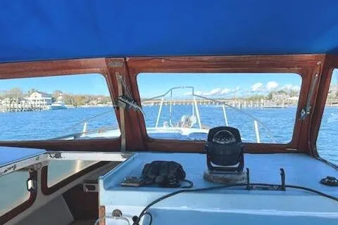 Slide: The Image of 1971 Dyer 29 Classic Downeast Bass Boat interior view, navigating calm waters. - 7