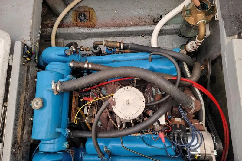 Slide: The Image of Engine of a 1971 Dyer 29 Classic Downeast Bass Boat, showcasing blue components and hoses. - 9