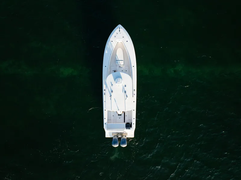 The Image of Aerial view of 2015 Contender 32 ST boat on dark green water. - 0