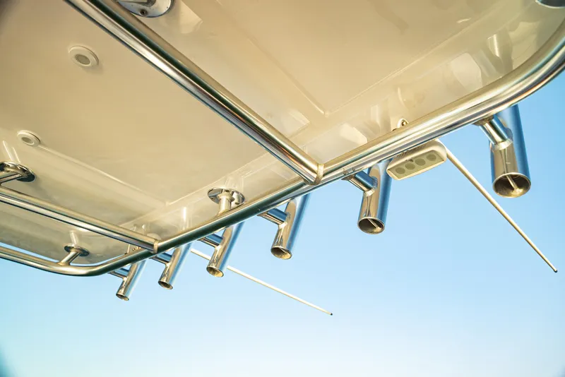 Slide: The Image of 2015 Contender 32 ST boat with rod holders against clear sky. - 13