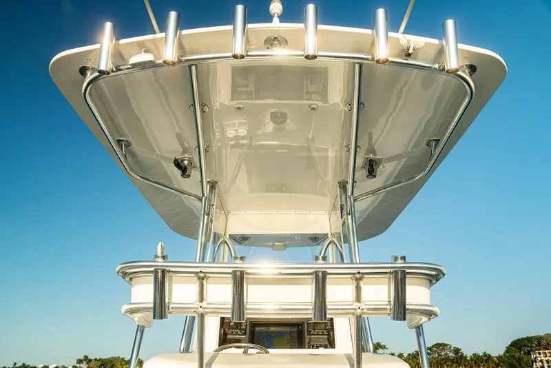 Slide: The Image of 2015 Contender 32 ST boat with T-top against clear blue sky. - 14