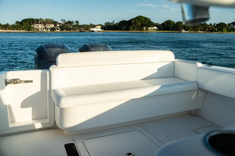 Slide: The Image of 2015 Contender 32 ST boat interior with white seating, ocean view in background. - 3