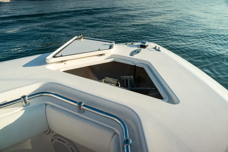 Slide: The Image of 2015 Contender 32 ST boat with open anchor hatch on calm water. - 4
