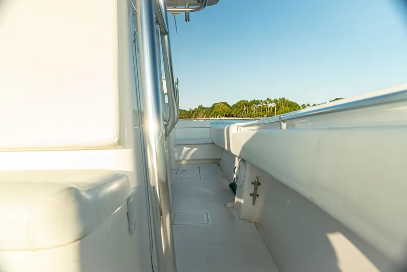 Slide: The Image of 2015 Contender 32 ST boat deck with clear sky and distant trees. - 9