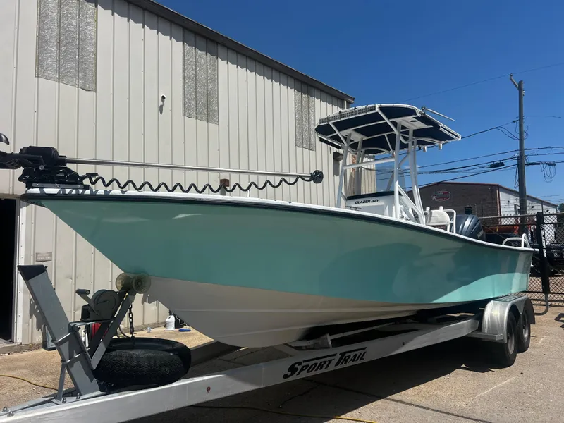 Slide: The Image of 2012 Blazer Bay 2400 boat console with steering wheel and control panel. - 10