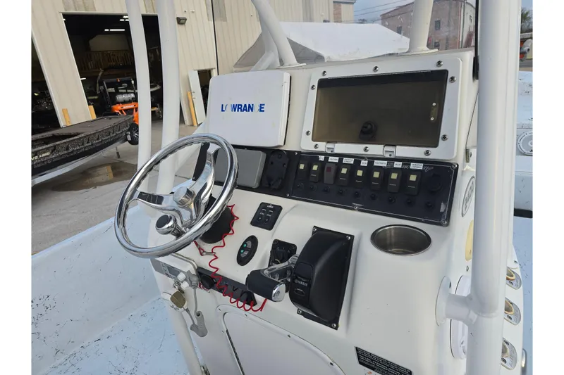 Slide: The Image of 2012 Blazer Bay 2400 boat console with steering wheel and control panel. - 11