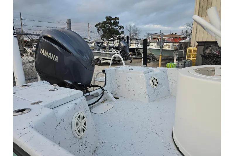 Slide: The Image of 2012 Blazer Bay 2400 boat with Yamaha outboard motor in a marina setting. - 12