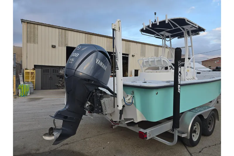 Slide: The Image of 2012 Blazer Bay 2400 boat with Yamaha V6 engine on trailer. - 13