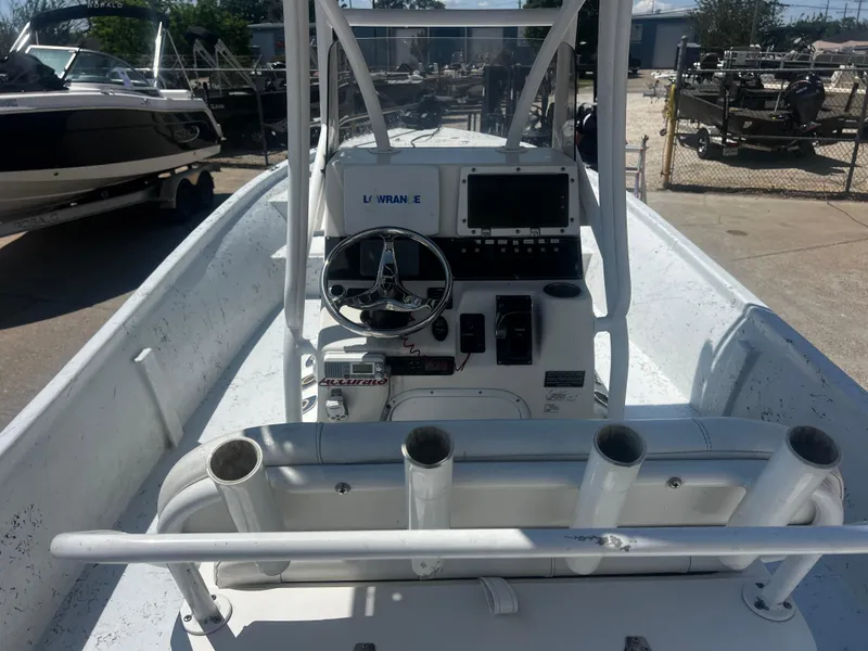 Slide: The Image of 2012 Blazer Bay 2400 boat with T-top, parked outdoors under cloudy sky. - 6