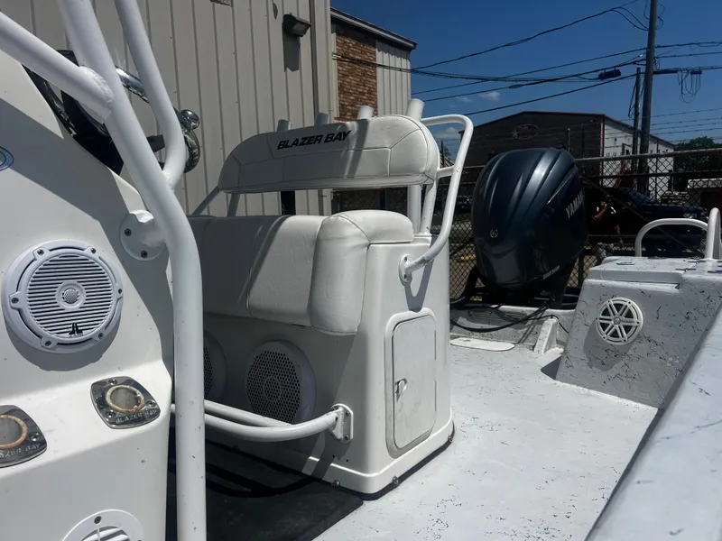 Slide: The Image of 2012 Blazer Bay 2400 boat interior with storage compartments and speakers. - 9