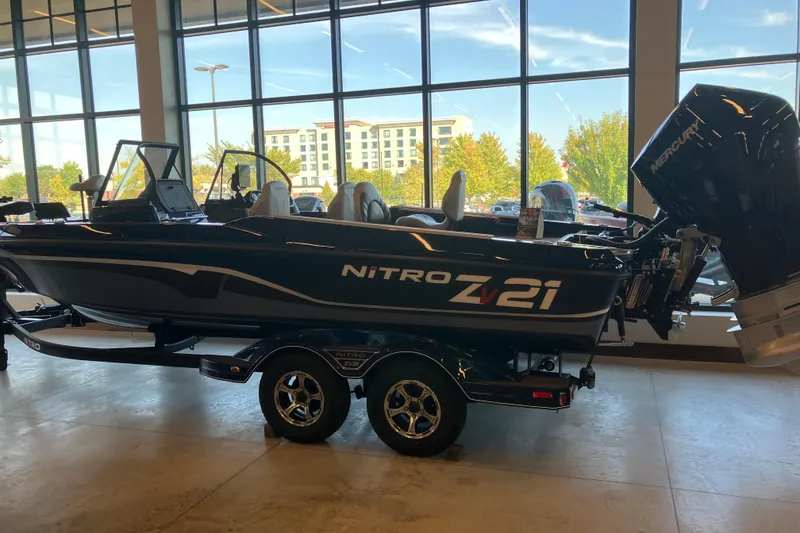The Image of 2025 Nitro ZV21 Pro boat displayed indoors with large windows in the background. - 0