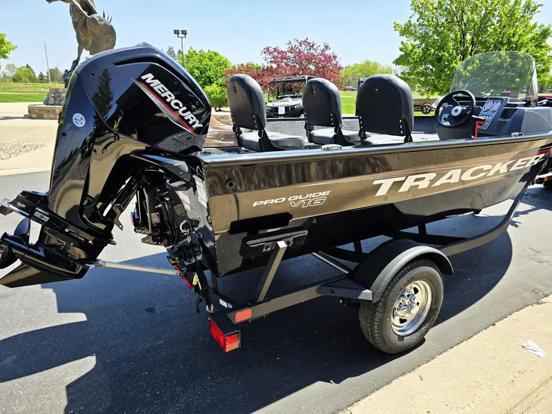 Slide: The Image of 2025 Tracker Pro Guide V-16 SC boat with Mercury engine on a trailer. - 2