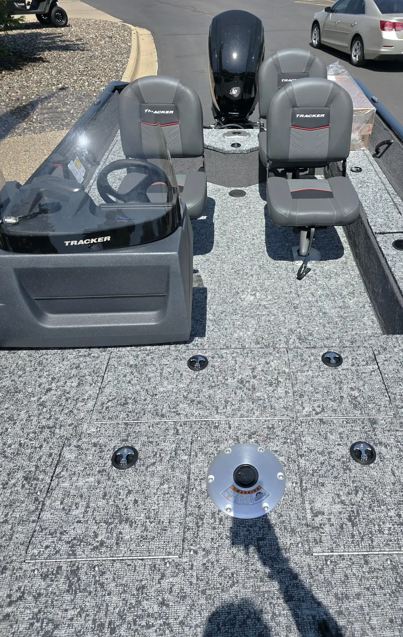 Slide: The Image of 2025 Tracker Pro Guide V-16 SC boat interior with seating and steering console. - 4