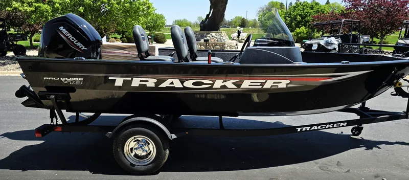 Slide: The Image of 2025 Tracker Pro Guide V-16 SC boat on trailer, side view, outdoors. - 5