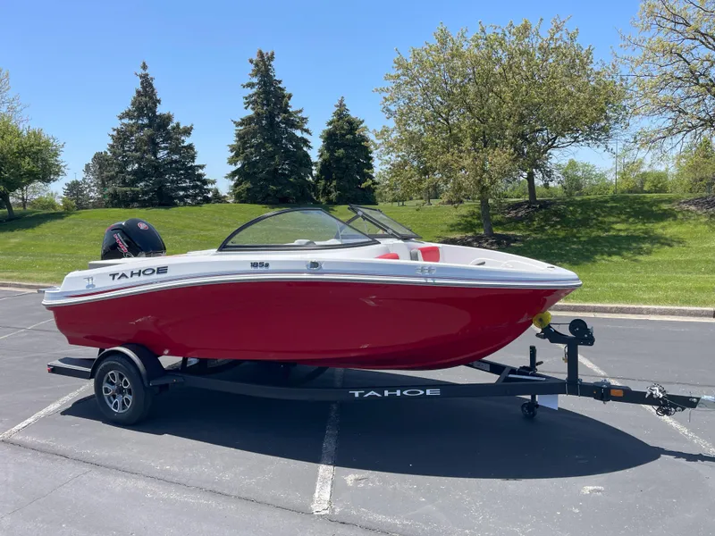 The Image of 2025 Tahoe 185 S boat on trailer, red and white, parked outdoors. - 0