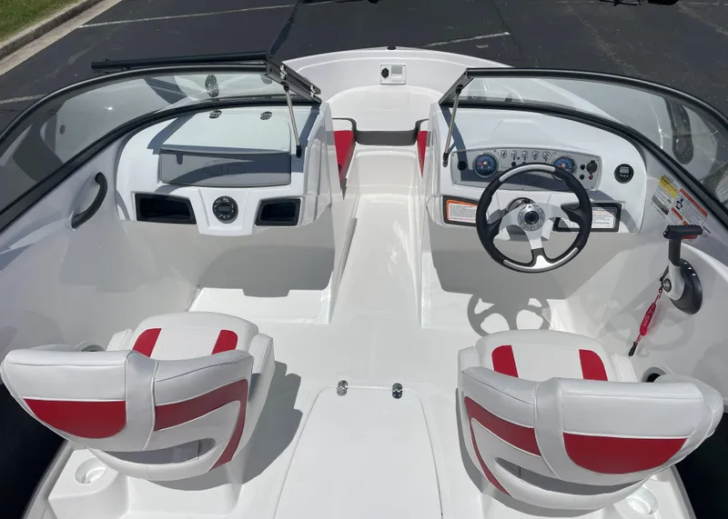 Slide: The Image of 2025 Tahoe 185 S boat interior with red and white seating, steering wheel, and dashboard. - 3