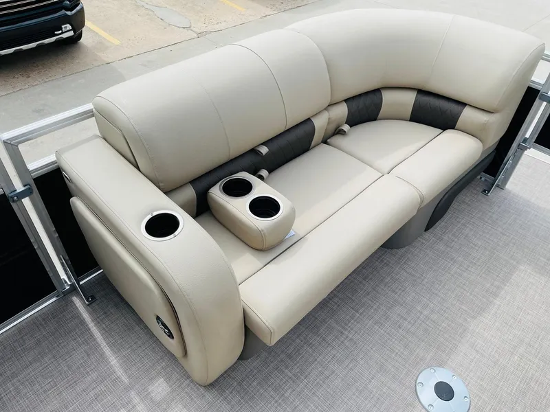 Slide: The Image of 2025 Sun Tracker SportFish 22 DLX pontoon boat seating with cup holders, beige upholstery. - 10