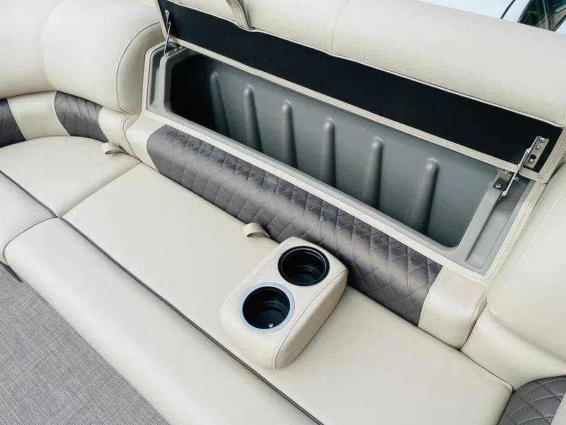 Slide: The Image of 2025 Sun Tracker SportFish 22 DLX boat seat with storage compartment and cup holders. - 16